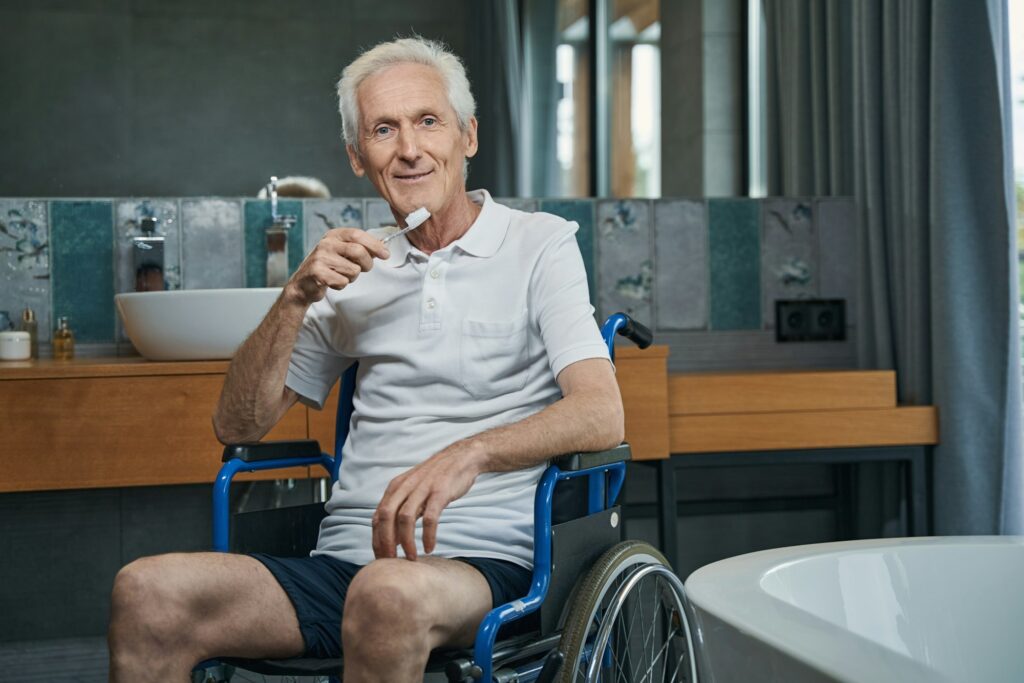 Pleased male person with disability holding toothbrush